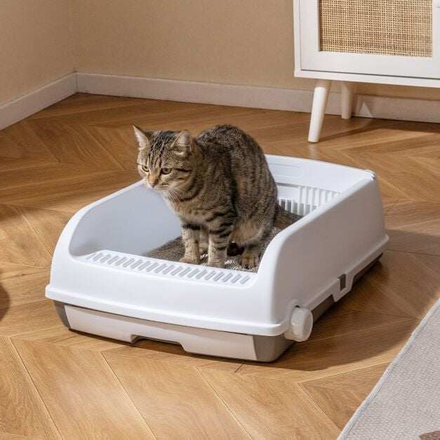 Semi-automatic cat litter box with open lid, drawer tray, and sliding scoop, white